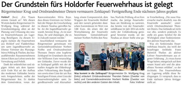 Zeitungsartikel der OV mit der Überschrift „Der Grundstein fürs Holdorfer Feuerwehrhaus ist gelegt“ und einem Foto von der Grundsteinlegung.