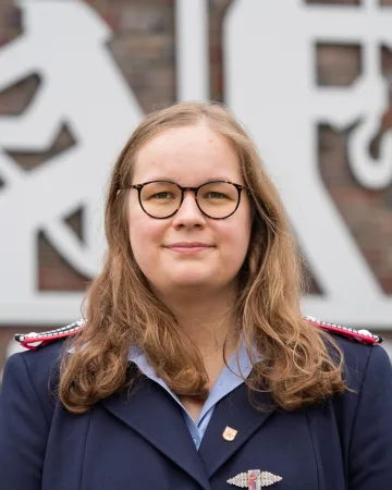 Porträt von Sina Schlotmann in dunkelblauer Dienstuniform.